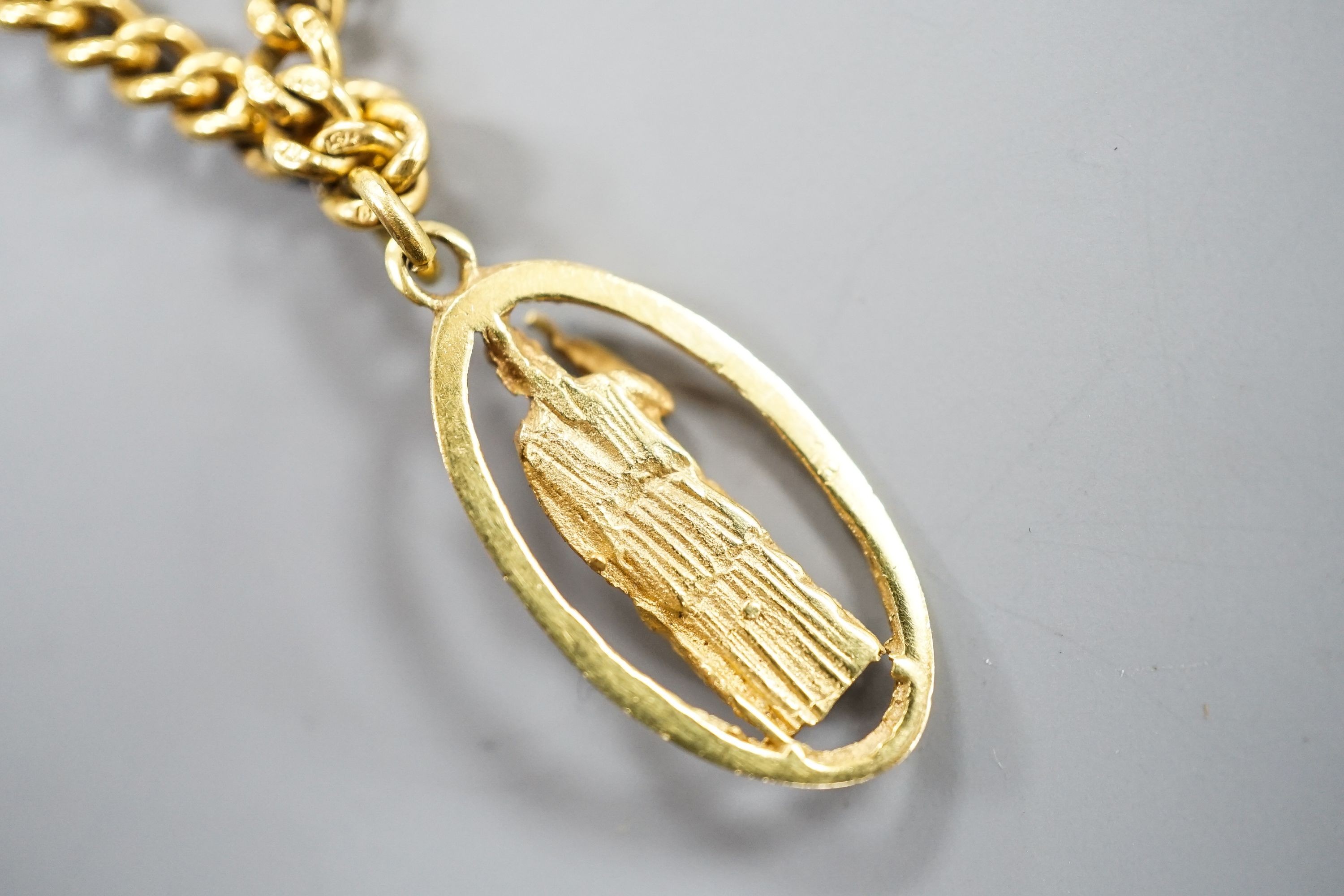 A 9ct curb link chain, 44cm, 15.7 grams, with a yellow metal St. Christopher pendant, engraved '18', 2.5 grams.